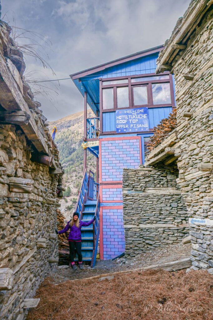 Image of a guesthouse in the Himalayas of Nepal in a village on the Annapurna Circuit Trek. Sustainable trips promote supporting local accommodations such as this one. 