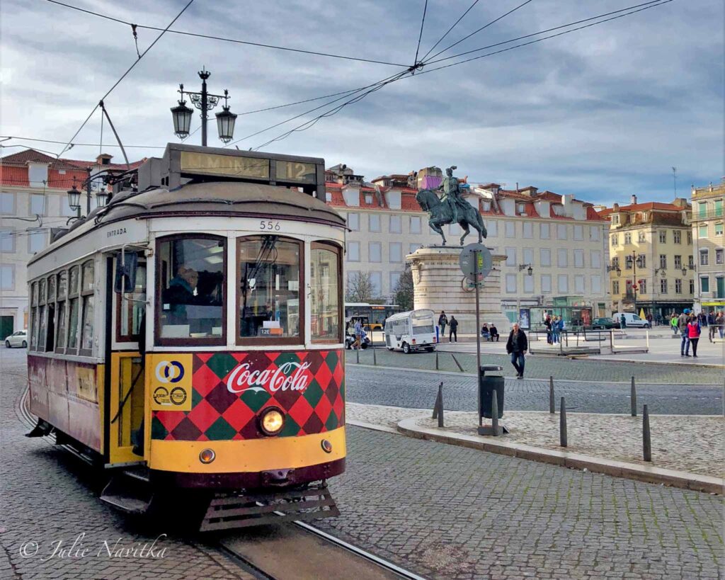Image of a tram with a plaza in background in Lisbon, Portugal. 