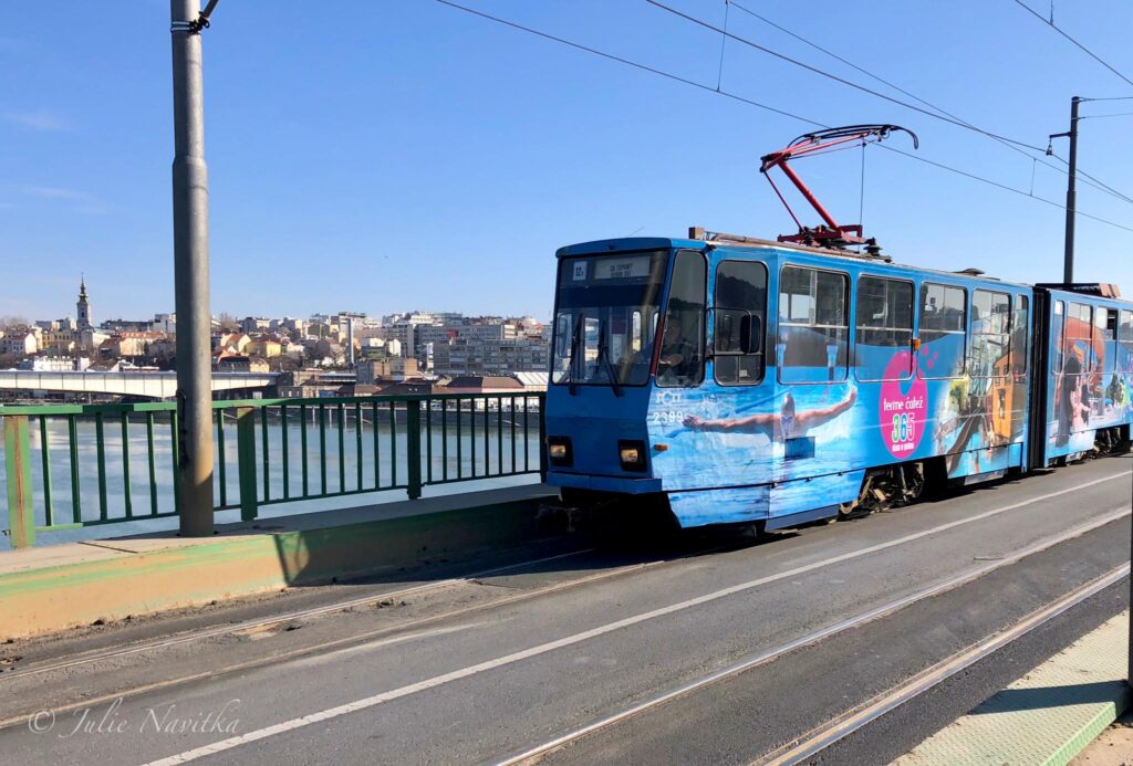 Image of a cable car crossing a bridge in Belgrade, Serbia. Public transportation promotes sustainability in cities.