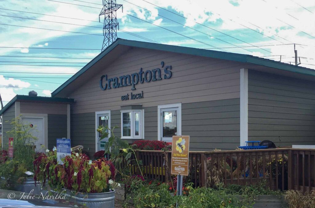 Image of a storefront reading "Crampton's: Shop Local." Shopping for produce that is in seasons at locally owned stores helps us be more economically and environmentally sustainable.