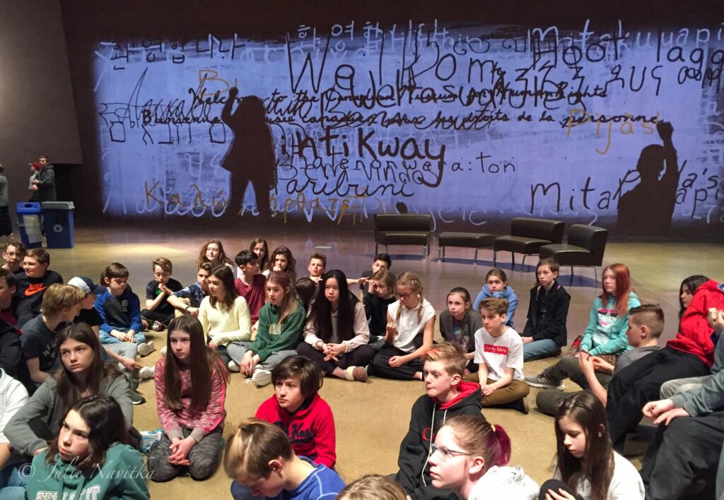 Image of a group of children sitting on the floor of the Canadian Museum for Human Rights located in Winnipeg, Manitoba. Social sustainability is one of the three main pillars of sustainable development and we shouldn't shy away from teaching these issues to our children.