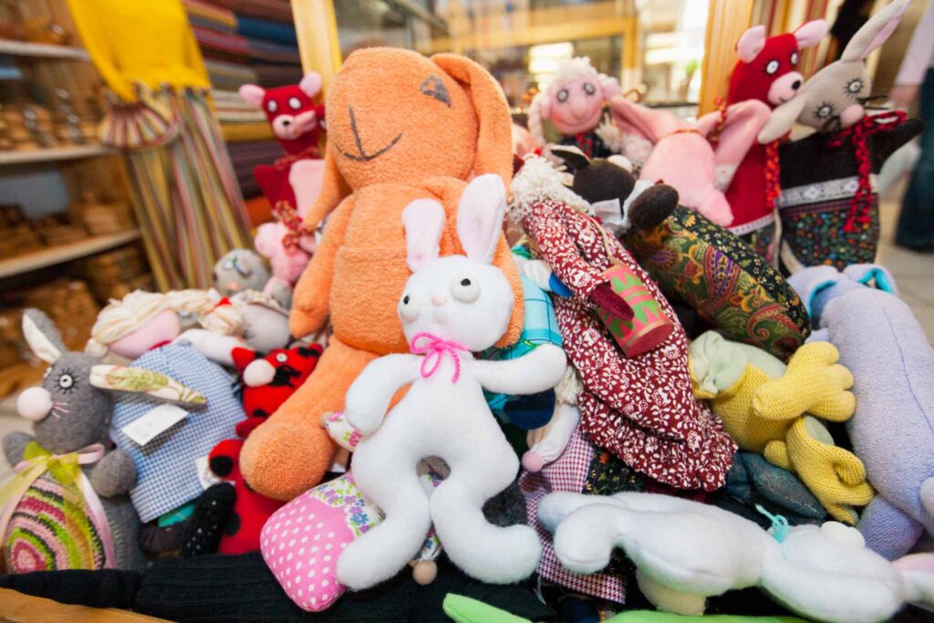 Image of a large pile of children's plush toys. Sustainable materials for stuffed toys include organic cotton.
