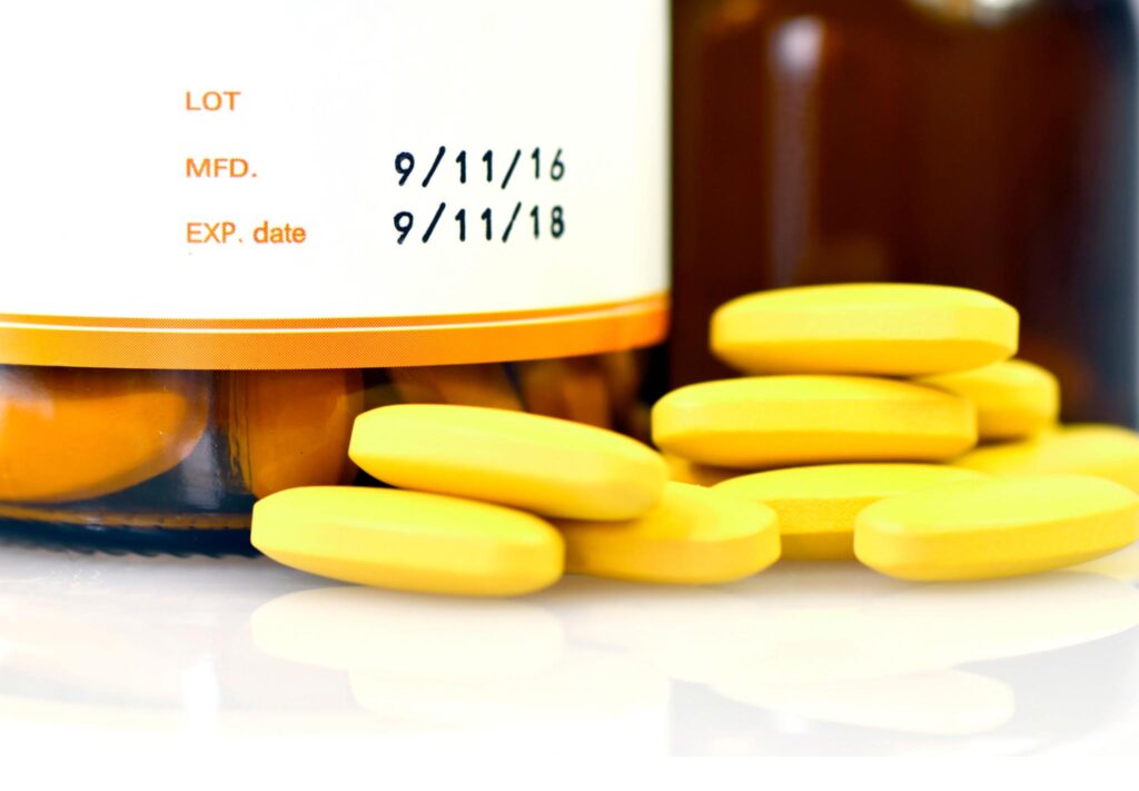 Close-up image of the expiry date on a bottle of medication. Storing cosmetics and medication properly to increase their shelf life and disposing of them properly can help you create a more sustainable health and beauty routine.