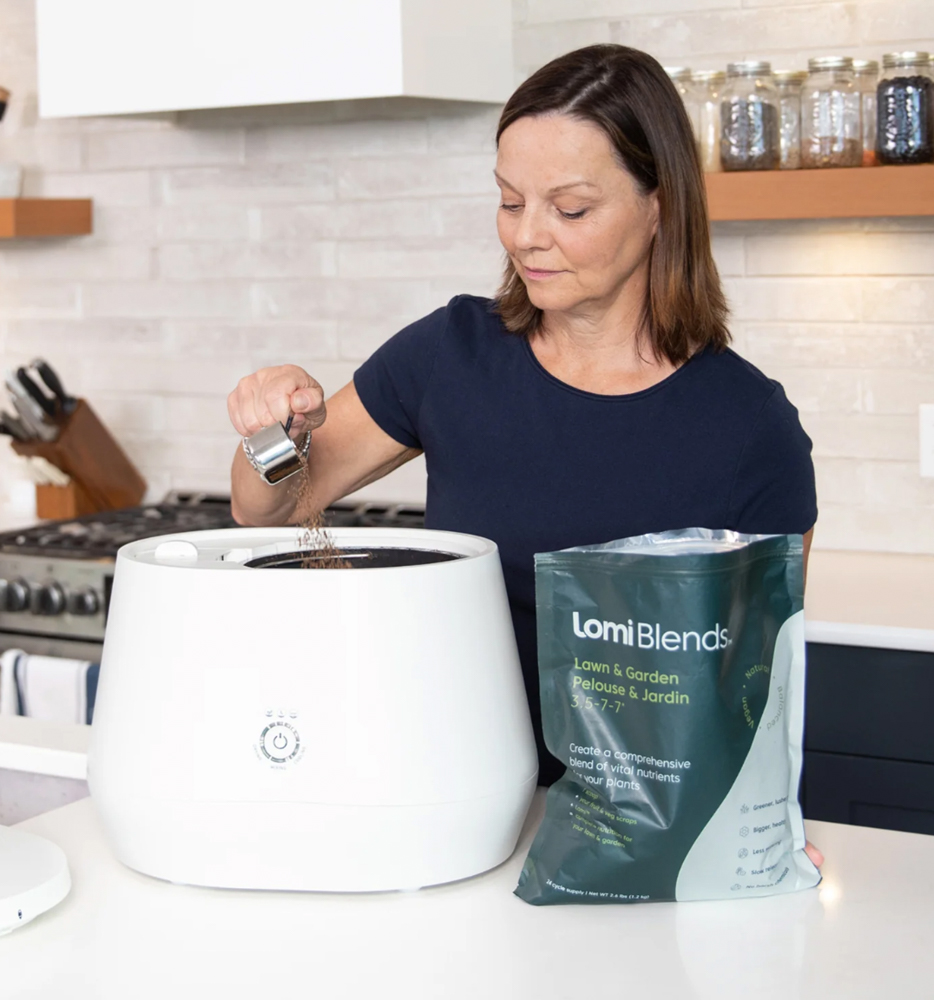 Image of a woman adding Lomi blends to her countertop Lomi Food Recycler.