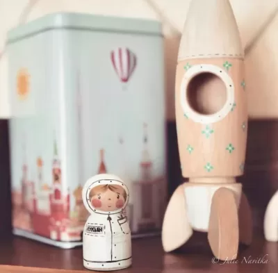 Image of a wooden astronaut and spaceship from Poppy Baby co. All natural fibers and components in toys lead to eco-child's play.