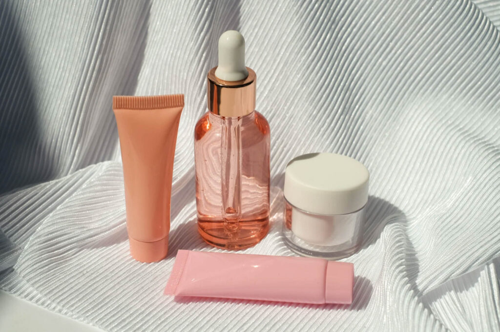 Image of a variety of a few pink coloured cosmetics containers. Disposing of old makeup properly is essential for a sustainable lifestyle.