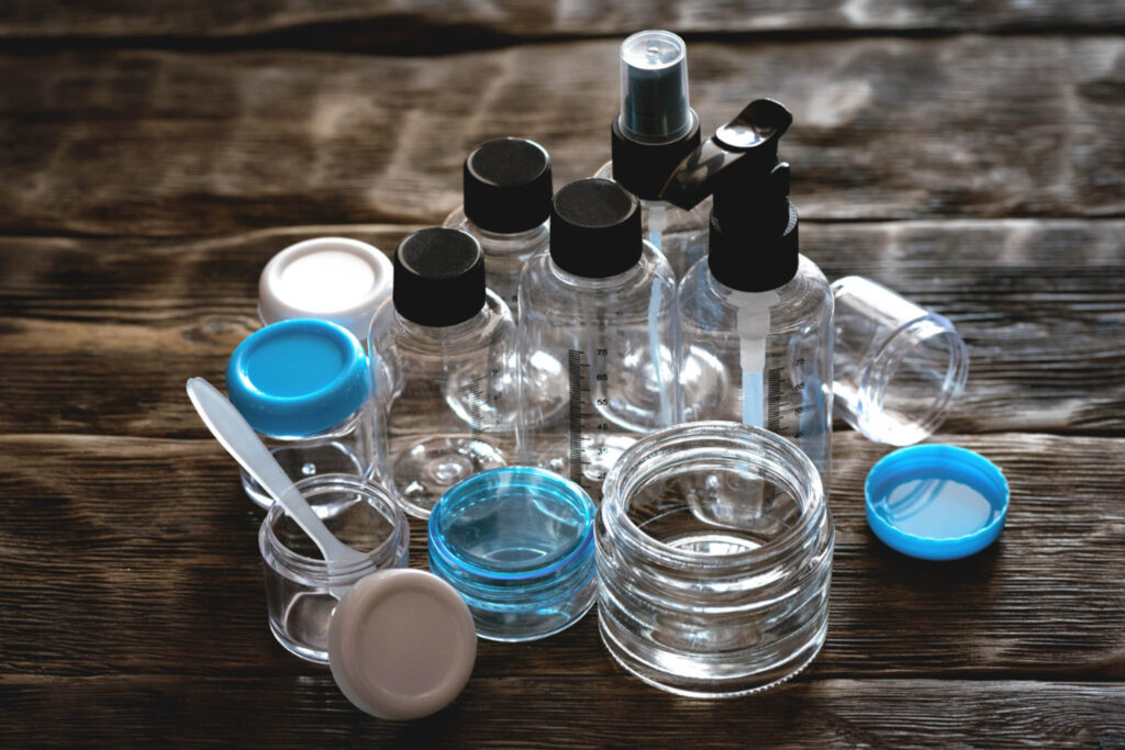 Image of a variety of empty, clean cosmetics containers and bottles.