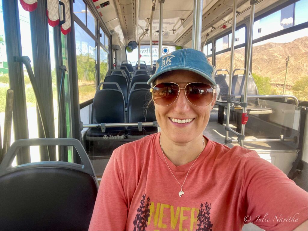 Image of author of site riding on a public bus. Using public transportation while living abroad is environmentally friendly.