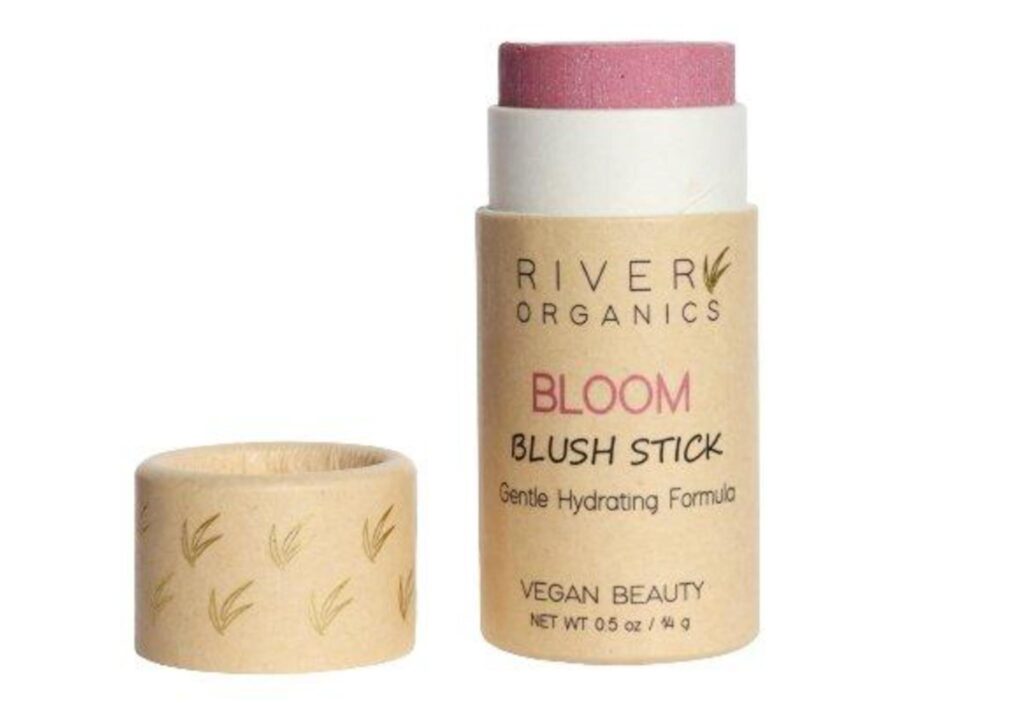 Image of a blush stick by River Organics made of cardboard with the lid off showing a dusty pink blush inside. Pure brands that create sustainable and non-toxic toiletries are good choices for clean beauty. 