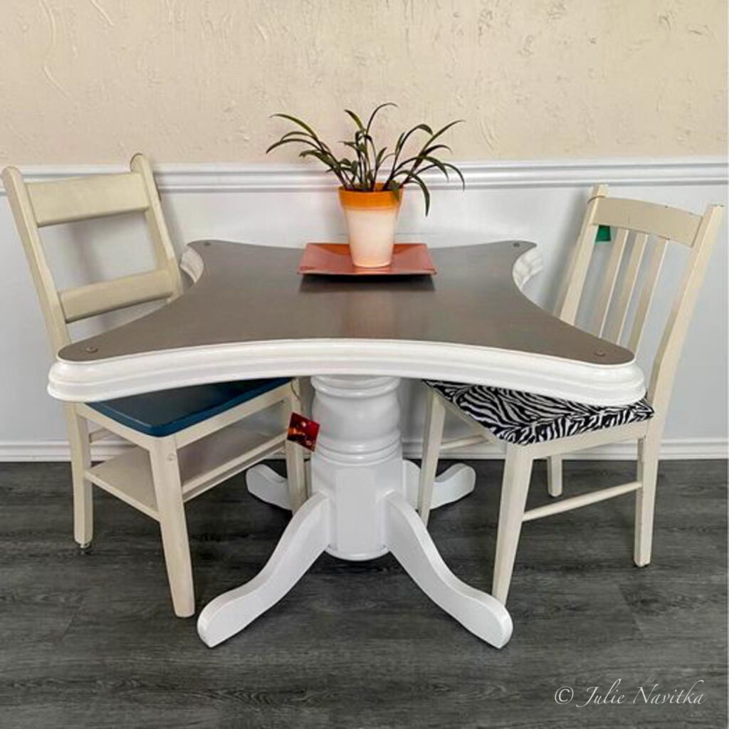 Image of a refinished two person dining table and chairs in a farmhouse style. 