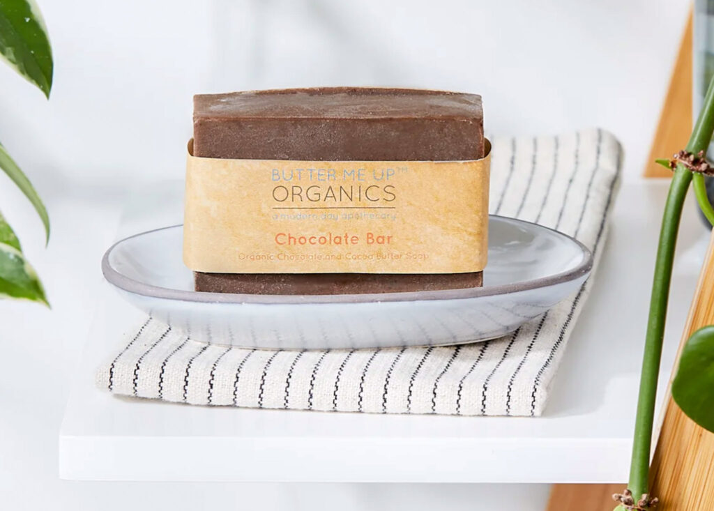 Image of the Butter Me Up Organics Chocolate Shampoo Bar sitting in a dish on a shelf.