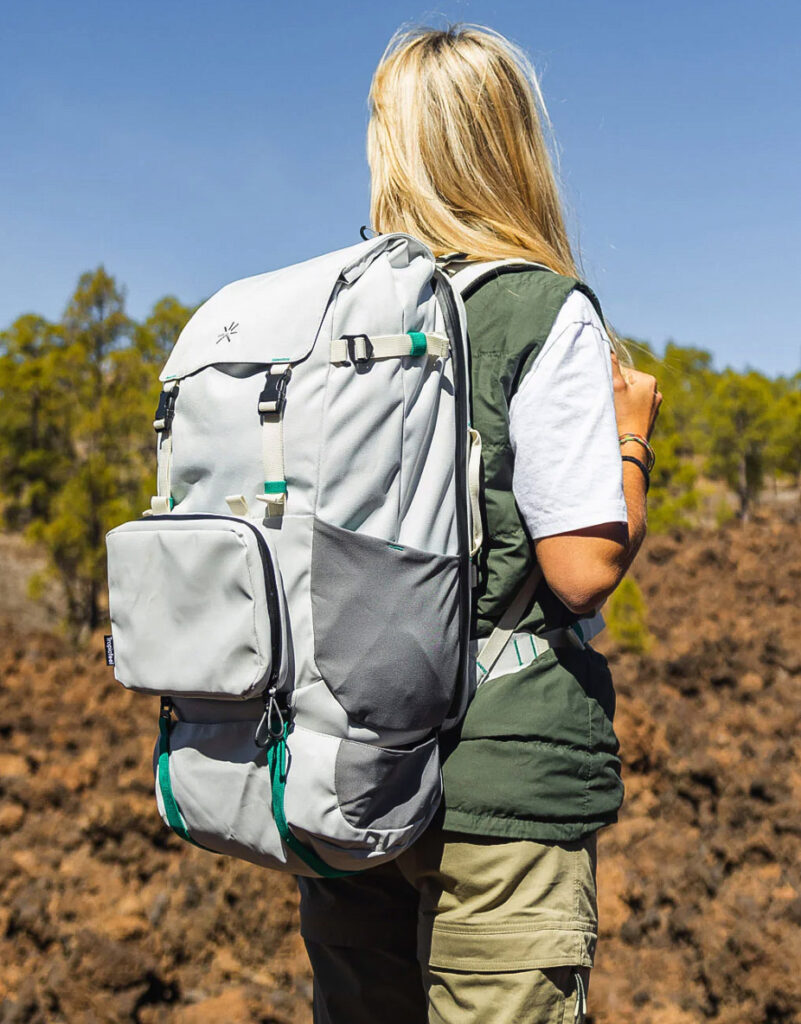 Image of a model wearing the Shell Backpack by Tropicfeel. Sustainable travel is made easy with this environmentally-friendly backpack!