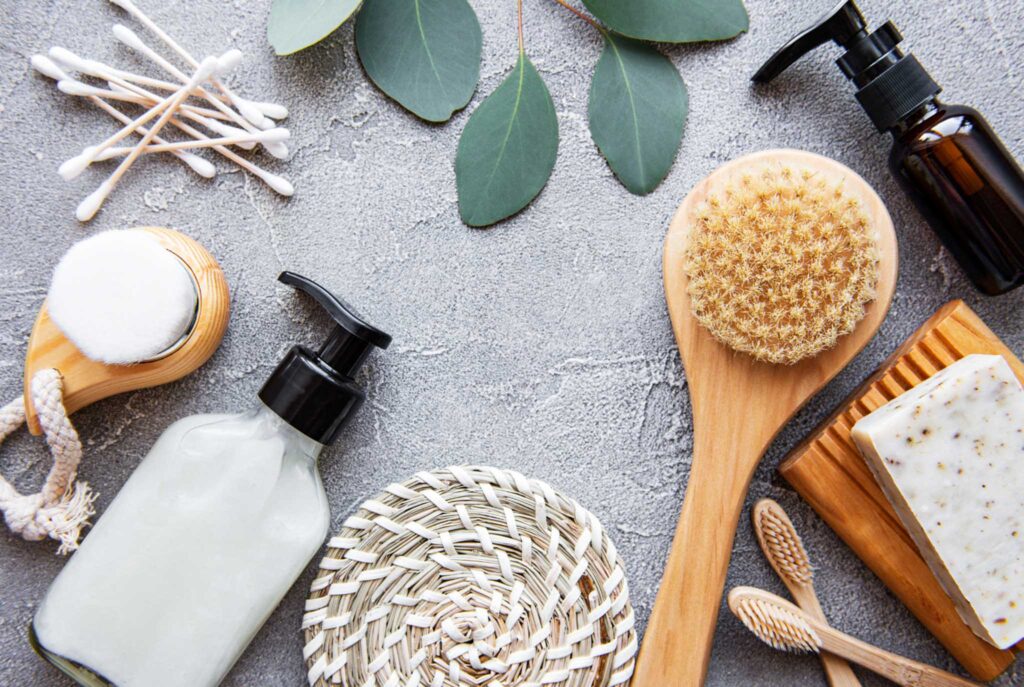 Image of numerous personal care products from above on a table, such as a bar of soap, ear swabs, and lotion. Beauty product certifications can help lead you to a more sustainable beauty routine.