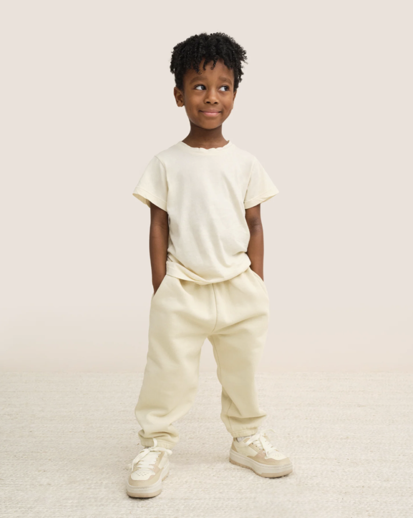 Image of a young child wearing an organic cotton t-shirt and sweatpants by MATE the label.
