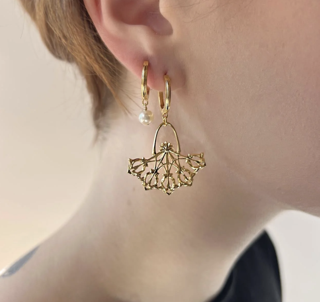 Image of a model wearing the Daphne Earrings in Gold by Astor & Orion.