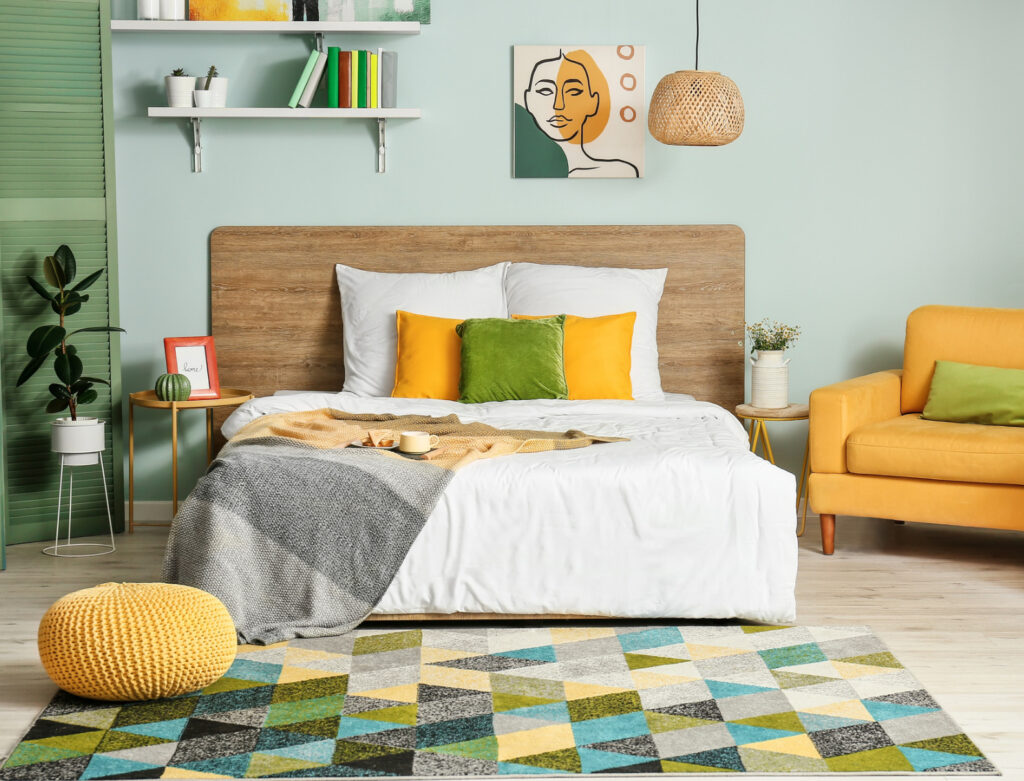 Image of a simply-styled green and yellow bedroom beautifully decorated with ethical bedroom accessories.