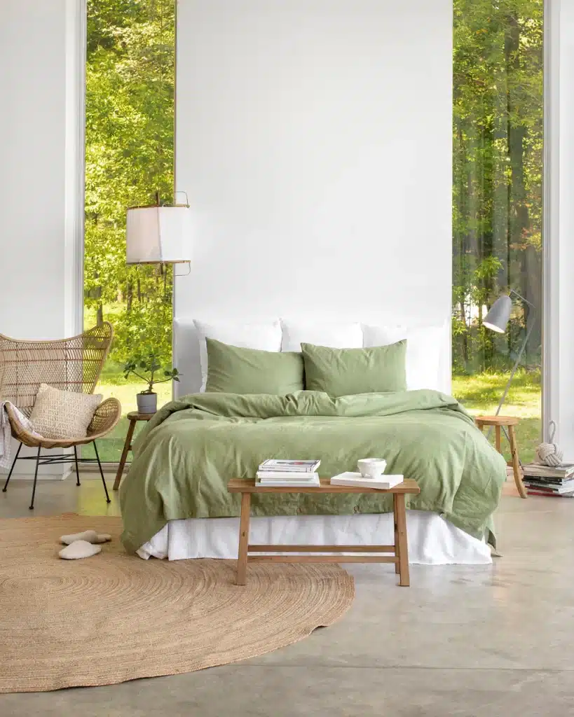 Image of a bed in a simple room with the Sage Green duvet by Magic Linen.