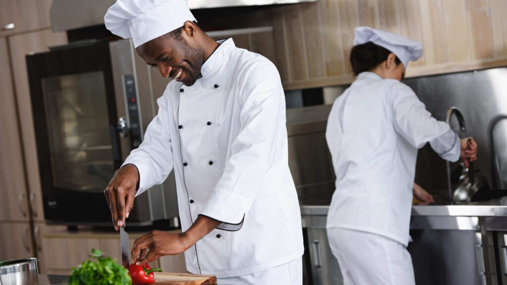Image of two chefs working in a kitchen. Sustainability in the workplace is an important factor in job satisfaction and employee engagement.
