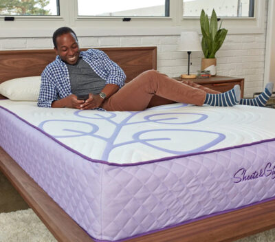 Image of a man laying on a eucalyptus mattress made by Sheets and Giggles.