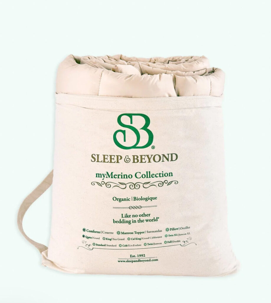 Image of the organic wool comforter by Sleep and Beyond rolled up in it's bag. 