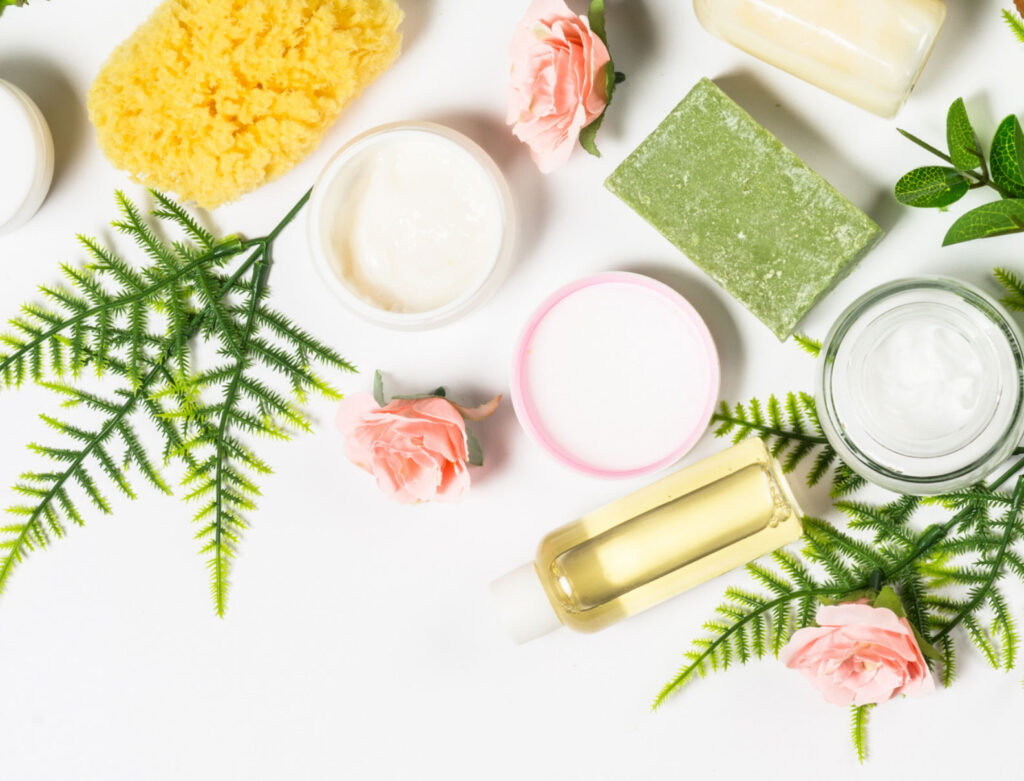 Image of natural and clean beauty products from above on a white surface. Non-toxic toiletries are better for the natural environment and your health!