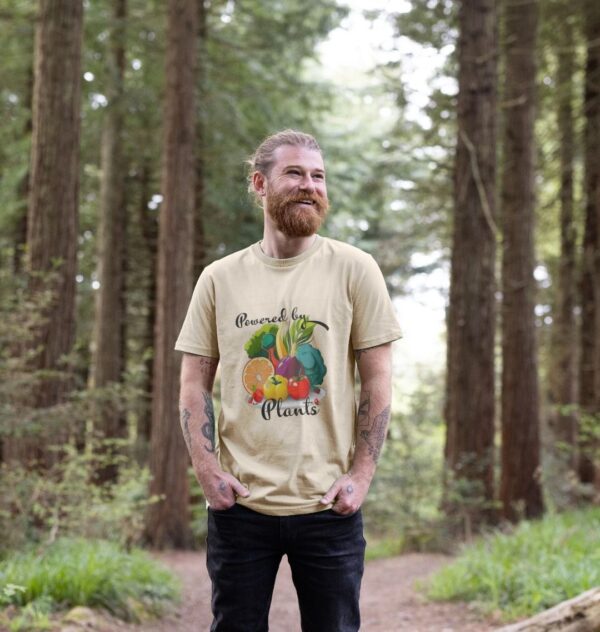 Image of a model wearing the Powered by Plants Tee in Oat.