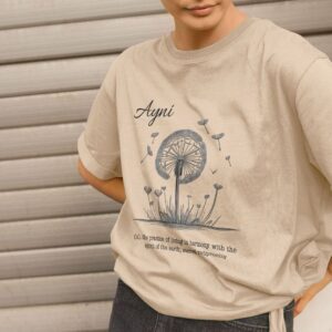 Image of a model wearing the Harmony with Earth Tee in Oat