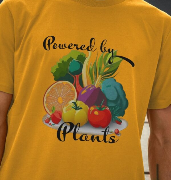 Image of a model wearing the Powered by Plants Tee in Mustard