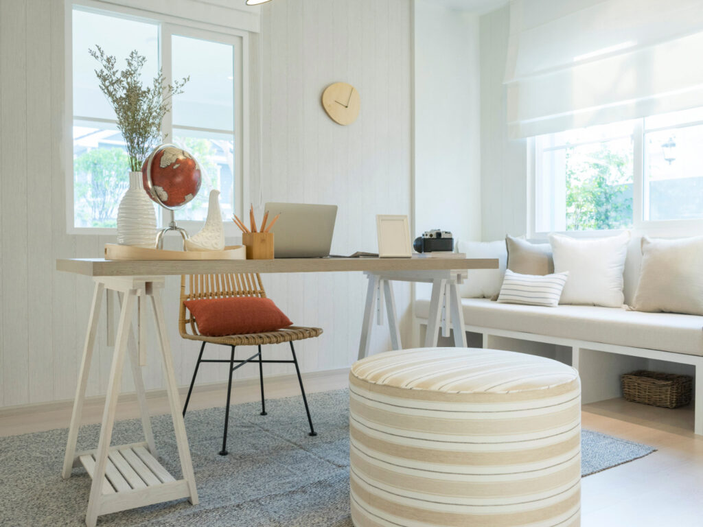 Image of a naturally-lit office with comfortable and light furniture.