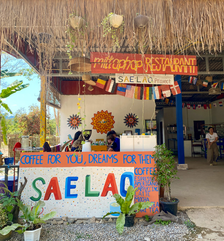 Image of the entrance to the Mitthap Restaurant, operated by Sae Loa Project, focused on sustainable practices. 