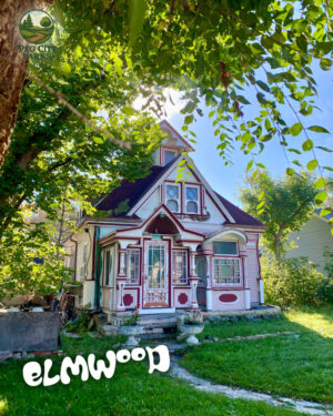 Image of a fairy-tale like house surrounded by greenery with the title "Elmwood" overlaid.