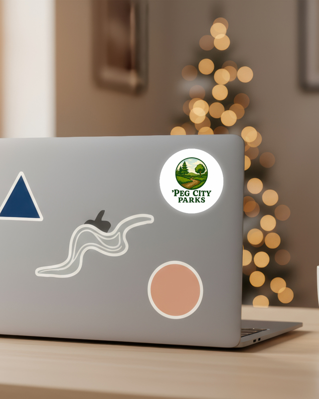 Image of the Peg City Parks circular glossy sticker on a laptop.