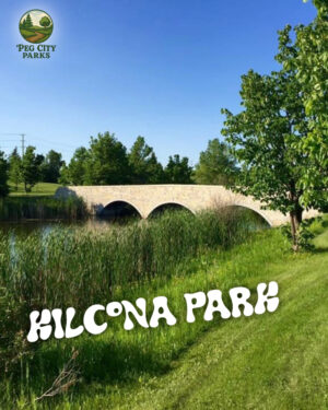 Image of the Kilcona Park Peg City Parks Scavenger Hunt cover - a stone bridge over water surrounded by greenery.